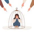 Girl locked in cage. Fingers pointing on sad muslim woman. Depressed teenager in hijab hugging knees and crying. School