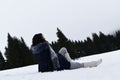 A girl seating in snow on mountain Kopaonik, Serbia, Europe