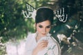 A girl with long, black hair decorated with Kandzashi, flowers and long pins with crystal beads. Portrait of a geisha