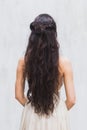 Girl with long black hair in a gentle silk wedding dress