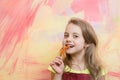 Girl with long blond hair eating red chilly pepper Royalty Free Stock Photo