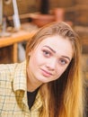 Girl with long blond straight shining hair posing indoors. Beautiful teenage model wearing boyish retro outfit. Female