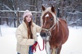 girl with long brown hair and chestnut horse with plaited mane close up portrait on winter snowy background Royalty Free Stock Photo