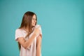 Girl with long brown hair and white T-shirt wagging her finger at someone. Royalty Free Stock Photo