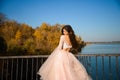 girl with long dark hair in a lush pale pink ball gown in autumn on a sunny day Royalty Free Stock Photo