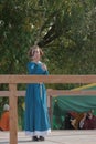 A girl in a long dress demonstrates her sword skills Royalty Free Stock Photo