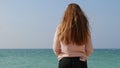 Girl with long ginger red hair enjoying sea breeze against background of seascape. Sea breeze playing with hair Royalty Free Stock Photo