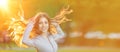 Girl with long hair on the background of the sunset. Female model in the sun smiling in the park. Summer time scene Royalty Free Stock Photo