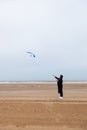 Girl rain sea wind winter portrait woman smile spring coat long hair curly mood shore snow beach kite Royalty Free Stock Photo