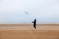 Girl rain sea wind winter portrait woman smile spring coat long hair curly mood shore snow beach kite Royalty Free Stock Photo