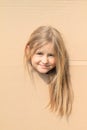 Girl with long hair looking thru hole Royalty Free Stock Photo