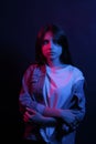 The girl with long hair and neon lights. Trend neon light. The concept of the psychological problems of the teenager Royalty Free Stock Photo