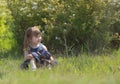 A girl with long hair sits in the spring garden Royalty Free Stock Photo