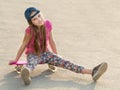 Girl with long hair sitting on skating board Royalty Free Stock Photo