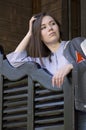 Girl with long hair stands near the wooden doors Royalty Free Stock Photo