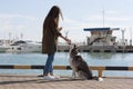 A girl with long hair treats the dog a treat Royalty Free Stock Photo