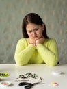 Girl with long hair and a yellow sweater Weaves Beaded jewelry Royalty Free Stock Photo