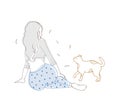 Girl with long loose hair dressed in dotted pajamas sitting on floor and looking at cat. Pretty woman and her pet animal