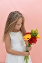 girl with long wavy hair holds bright flowers Royalty Free Stock Photo