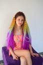 A girl with a long wavy hair painted in rainbow colors. Tunic hair kanekalon Royalty Free Stock Photo