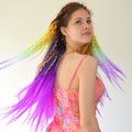 A girl with a long wavy hair painted in rainbow colors. Tunic hair kanekalon Royalty Free Stock Photo