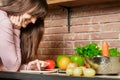 Girl look at the tablet.Young Woman Cooking in the kitchen at home. Healthy Food.