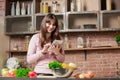 Girl look at the tablet.Young Woman Cooking in the kitchen at home. Healthy Food.