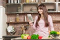 Girl look at the tablet.Young Woman Cooking in the kitchen at home. Healthy Food.