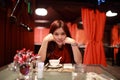 Girl  look at you face to face, she rest her chin on the hand, waiting the dinner in the romantic restaurant in hong kong Royalty Free Stock Photo