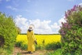 Girl lookign over a rapeseed field