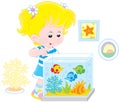 Girl looking at aquarium fishes Royalty Free Stock Photo