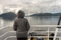 Girl looking at the beautiful scenery from a boat from Molde to Aalesund in Norway during summer holiday. Royalty Free Stock Photo