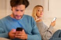 Girl Looking At Boyfriend Texting On Phone Suspecting Infidelity, Indoor Royalty Free Stock Photo