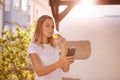 Girl looking at cellphone sipping beer