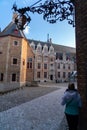 Girl is looking at Church Of Our Lady and traditional narrow streets in Bruges