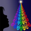 Girl looking colorful christmas tree