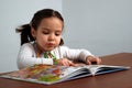 Girl looking in a colorful story book Royalty Free Stock Photo