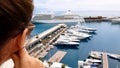 Girl looking at cruise liner from hotel terrace, waiting for embarkation on ship