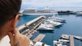 Girl looking at cruise liner from hotel terrace, waiting for embarkation on ship