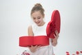 Girl looking down into a box containing a gift she received for Valentine`s day Royalty Free Stock Photo