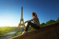 Girl looking at the Eiffel tower in sunrise time