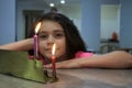 Girl Looking at the First Candles of Chanukah Jewish Holiday on