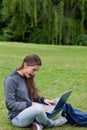 Girl looking at her laptop while sitting on the Royalty Free Stock Photo