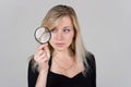 Girl looking through a magnifying glass