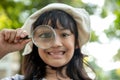 Girl looking through a magnifying glass