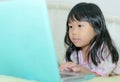 Girl looking at notebook - laying flat on the bed Royalty Free Stock Photo