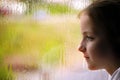 Girl looking out rainy window Royalty Free Stock Photo