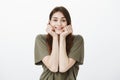 Girl looking outside, grinning of warm spring day. Portrait of happy dreamy woman, leaning head on hands and smiling