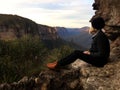 Girl looking over blue mountains