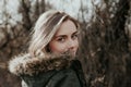 The girl is looking over her shoulder at camera in warm jacket Royalty Free Stock Photo